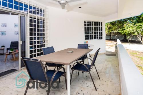 a dining room with a wooden table and chairs at Villa Xtohil with private access to the magic 7 colors lagoon in Bacalar