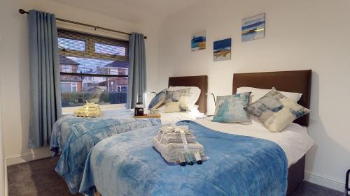a bedroom with two beds and a window at Redwood in Longton