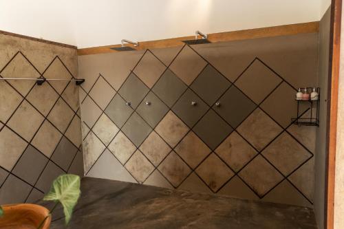 a shower stall in a bathroom with a tile wall at Casa na Lagoa in Paracuru