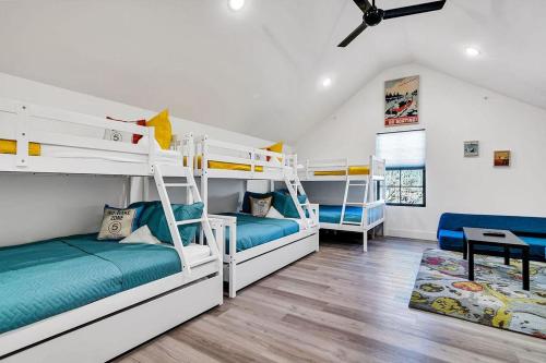a room with three bunk beds and a desk at Modern Rustic in Branson