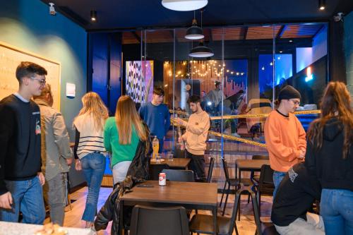 a group of people standing around in a restaurant at VAD HOSTEL ALICANTE in Alicante