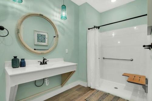 a bathroom with a sink and a mirror and a shower at A Wave From It All in Hollister