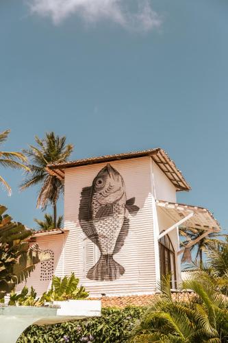 a mural of a fish on the side of a building at Casa na Lagoa in Paracuru
