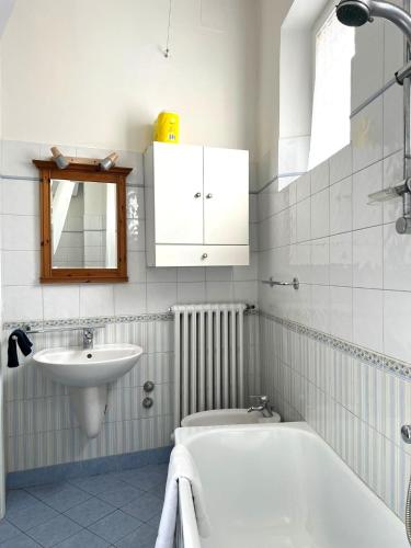 a bathroom with a bath tub and a sink at Residenza La Libertà in Florence