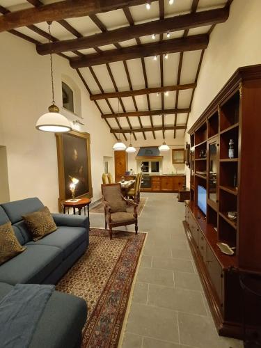 a living room with a blue couch and a tv at Il Rifugio del Vescovo in Vetralla