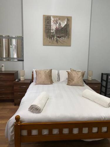 a bedroom with a large bed with white sheets at 007- S1premium location studio apartment central London in London