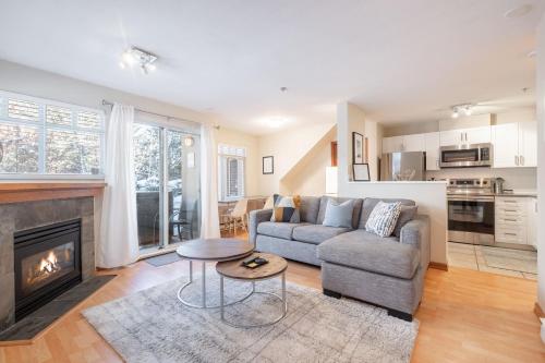 a living room with a couch and a fireplace at Lagoons by Outpost Whistler in Whistler