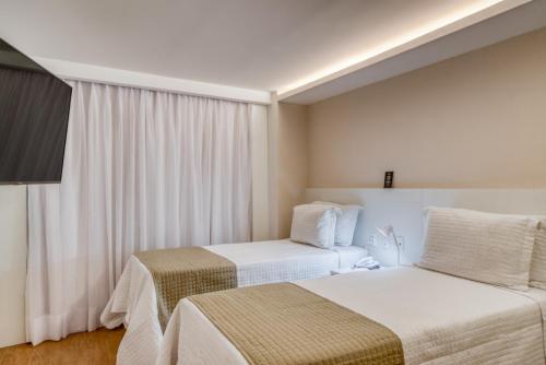 Ένα ή περισσότερα κρεβάτια σε δωμάτιο στο Hotel Brisa Suítes Pajuçara