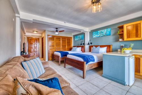 a living room with a bed and a couch at Tropical Suites Hotel in Bocas Town