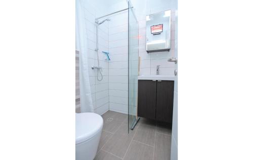 a bathroom with a toilet and a glass shower at Nice Home In Prigradica With Jacuzzi, Wifi And Outdoor Swimming Pool in Prigradica