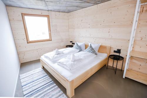 um quarto com uma cama num quarto de madeira em BOUTIQUE APARTMENTS LUSTENAU Nachhaltige Kühlung über Erdsonde und Fussbodenkühlung em Lustenau