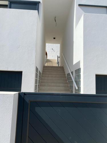 a dog is walking down a staircase in a building at Casa Monte y Mar in Morro del Jable