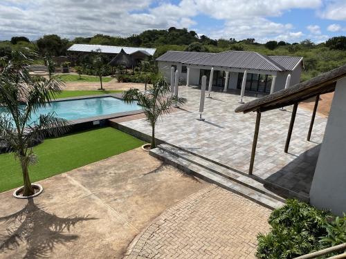 an aerial view of a house with a swimming pool at Bluewave Farm Villa in Louis Trichardt