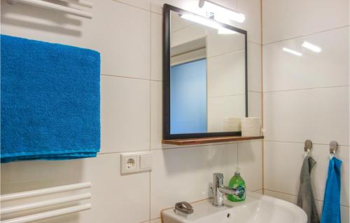 a bathroom with a sink and a mirror at Nice Apartment In Loxstedt With Kitchen in Loxstedt