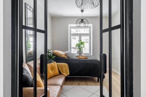a living room with a couch and a mirror at Fabia in Turku