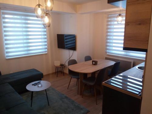 a living room with a couch and a table at Apartmani NIX VIR in Jahorina