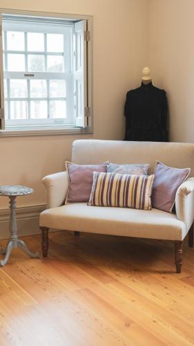 a couch in a living room with a window at Quinta de Travassinhos- Douro Valley & Spa in Santa Marta de Penaguião