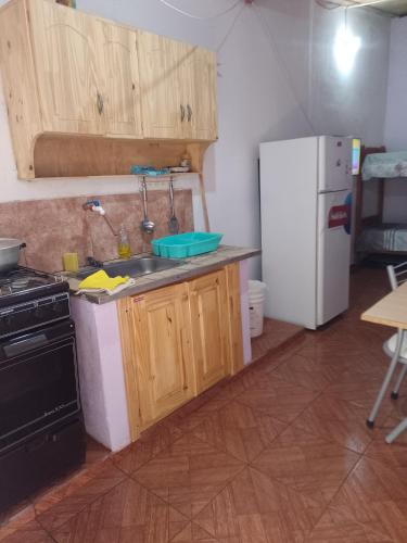 a kitchen with a sink and a refrigerator at Don José in Posadas