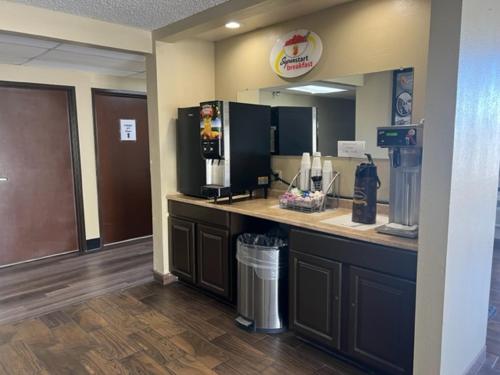 a coffee shop with a counter with a drink dispenser at Super 8 Belen in Belen