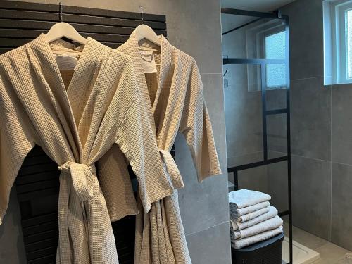 a robe hanging on a rack in a bathroom at domaine de la bergerie in Zuid-Beijerland