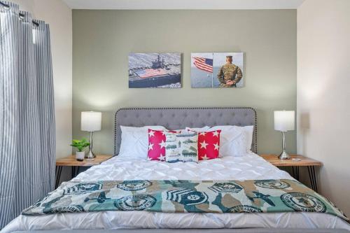 a bedroom with a bed with pillows and pictures on the wall at HEIRS VENTURES : Patriot . Near Civic Center . Museum . OKC Thunder Arena . With Washer and Dryer in Oklahoma City