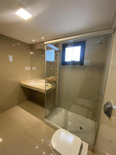 a bathroom with a shower and a toilet and a sink at HOTEL CASTELAR CORDOBA in Córdoba
