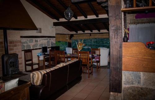 a restaurant with tables and chairs and a fireplace at CASA RURAL EL RONDILLO in Navaconcejo