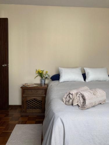 a bedroom with two beds and a table with a towel at Departamento acogedor en la mejor zona de La Paz in La Paz