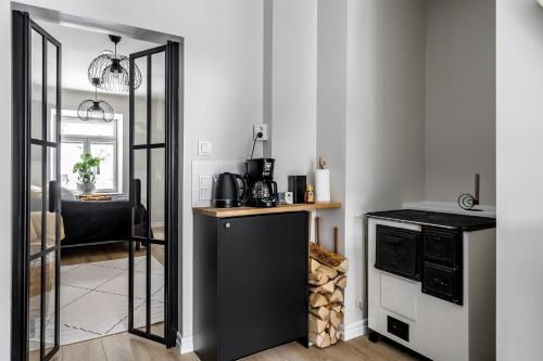 a living room with a mirror and a kitchen at Fabia in Turku