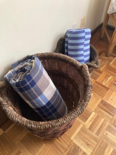 two baskets sitting on the floor in a room at Departamento acogedor en la mejor zona de La Paz in La Paz