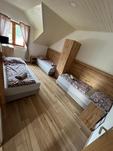 a room with three beds in a attic at Ranč pod Babicou in Bojná