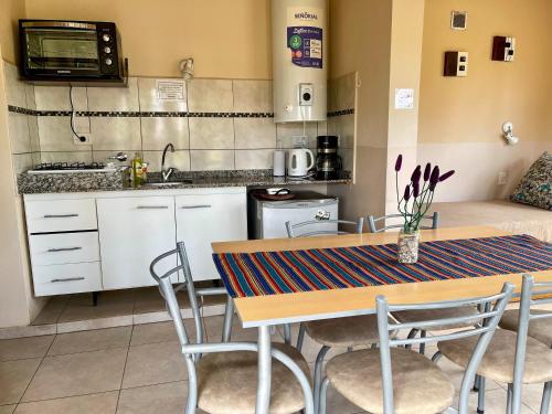 a kitchen with a table and chairs in a room at Cabañas EcoNature in Valle Grande