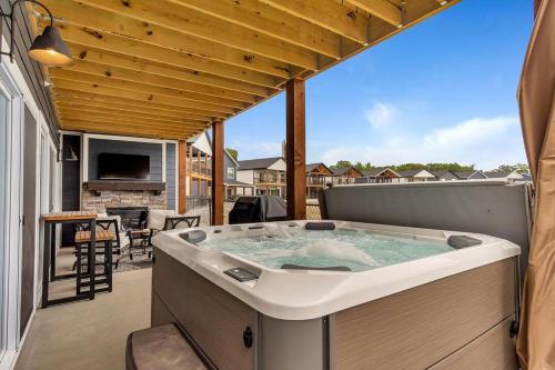 a large hot tub on a patio with a table at Idle Time at Table Rock Lake in Branson
