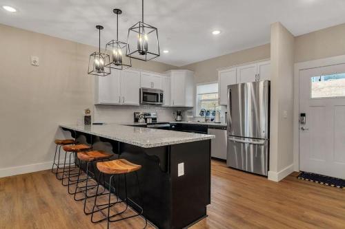a kitchen with a large black island with bar stools at Idle Time at Table Rock Lake in Branson