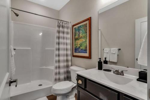a bathroom with a sink and a toilet and a shower at Idle Time at Table Rock Lake in Branson
