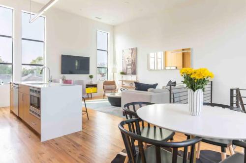 a kitchen and living room with a table and chairs at Glamorous Perfectly Located Luxury 2 Bed Townhome in Dallas