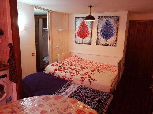 a small room with two beds and a table at Singlin Home in Valtournenche