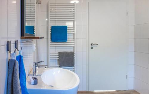 a bathroom with a white sink and a mirror at 2 Bedroom Awesome Apartment In Loxstedt in Loxstedt