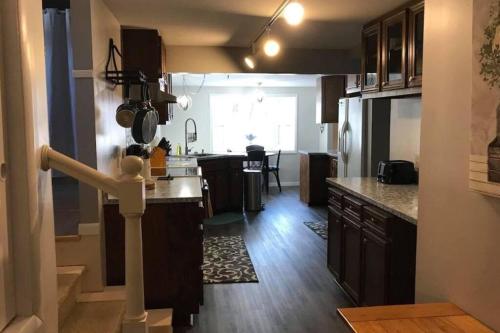 a kitchen with brown cabinets and a counter top at Bring the Whole Family! in Sault Ste. Marie