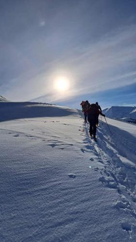 a person is walking through the snow at Vila Latphari in Ushguli in Ushguli