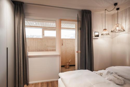 a bedroom with a bed and a window at apartments55 in Bressanone