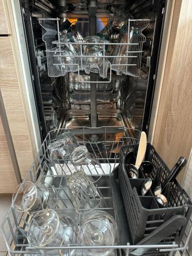 an open dishwasher with dishes and glasses in it at Apartment II Am Jakobsweg in Erfurt