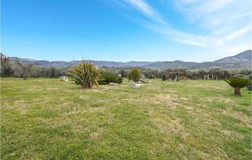 a field of grass with mountains in the background at Gorgeous Apartment In Cori With Kitchen in Cori