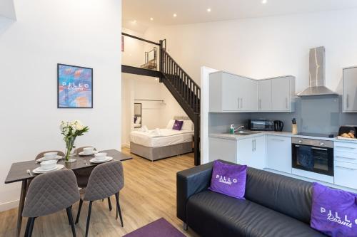 a living room with a couch and a table at Pillo Rooms Serviced Apartments - Manchester Arena in Manchester