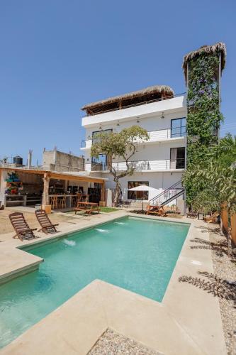 a swimming pool in front of a building at SurfNest Tamarindos in Brisas de Zicatela