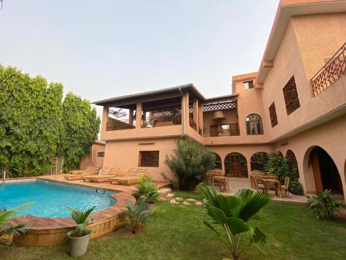 a house with a swimming pool in the yard at Nomads in Lomé