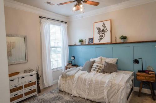 a bedroom with a bed and a ceiling fan at Charming 5 Bedroom spacious Home (sleeps 12-14) in Piedmont