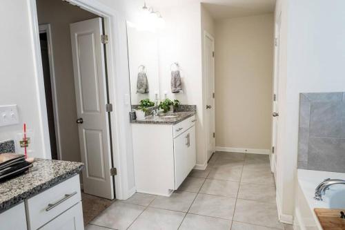 a white kitchen with a sink and a counter at Charming 5 Bedroom spacious Home (sleeps 12-14) in Piedmont