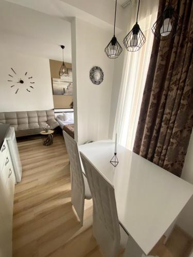 a white dining room with a white table and chairs at Апартамент под наем С208 в Афродита Гарденс in Sunny Beach