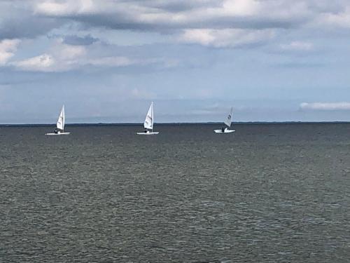 three sailboats in the ocean on the water at Willa Davia in Rewa